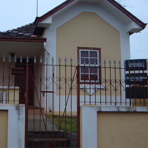 Por entre as grades da antiga casa de Nuporanga/SP nota-se uma placa indicando a presença de um escritório de advocacia. 